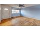 Living room with hardwood floors, light blue walls, and a ceiling fan at 13643 E Exposition Ave, Aurora, CO 80012