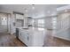 Modern kitchen featuring white cabinets, island, and fireplace at 24801 E 33Rd Dr, Aurora, CO 80019