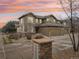 Two-story townhome with stone accents, neutral color scheme, and a two-car garage at 7616 S Sicily Way, Aurora, CO 80016