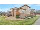 Tan two-story home with stone accents and deck at 7616 S Sicily Way, Aurora, CO 80016