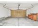 Empty two-car garage with light colored flooring and an overhead door at 7616 S Sicily Way, Aurora, CO 80016