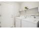 Laundry room with washer, dryer, and shelving at 7616 S Sicily Way, Aurora, CO 80016