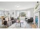 Bright living room featuring a fireplace and large windows at 7616 S Sicily Way, Aurora, CO 80016