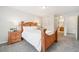 Main bedroom with wood bed frame and en-suite bath at 7616 S Sicily Way, Aurora, CO 80016