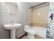 Clean bathroom featuring a pedestal sink, toilet, and a shower-tub combination with decorative tiles at 9400 E Iliff Ave # 37, Denver, CO 80231