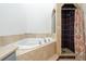 Bathroom showcasing a bathtub, shower, and decorative tile work at 9400 E Iliff Ave # 37, Denver, CO 80231