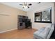 Cozy bedroom with neutral walls, wood floors, a ceiling fan, a work station, and a comfortable seating area at 9400 E Iliff Ave # 37, Denver, CO 80231