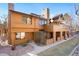 Charming multi-level townhouse featuring a brick chimney, a well-kept lawn, and wood-finished siding at 9400 E Iliff Ave # 37, Denver, CO 80231