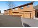 Multi-unit townhouse featuring private garages and exterior lighting at 9400 E Iliff Ave # 37, Denver, CO 80231