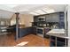 Well-lit kitchen featuring dark cabinets, stainless steel appliances, granite countertops, and sleek backsplash at 9400 E Iliff Ave # 37, Denver, CO 80231