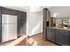 Kitchen featuring dark cabinetry, stainless steel appliances, and wood floors at 9400 E Iliff Ave # 37, Denver, CO 80231