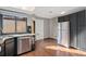 Bright kitchen area with stainless steel appliances, dark cabinets, and granite countertops at 9400 E Iliff Ave # 37, Denver, CO 80231