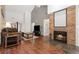 Bright living room with wood floors, a cozy fireplace, and comfortable seating, creating an inviting atmosphere at 9400 E Iliff Ave # 37, Denver, CO 80231