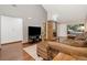 Spacious living room featuring wood floors, a gray accent wall, and large windows that brighten the space at 9400 E Iliff Ave # 37, Denver, CO 80231