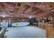 Unfinished basement offering ample storage space, with visible ceiling framework and concrete flooring at 45 Oak Way, Evergreen, CO 80439