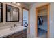 Bathroom featuring a single sink vanity with granite countertop, one mirror and closet space at 45 Oak Way, Evergreen, CO 80439