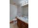 Bathroom with a single sink vanity, neutral tile flooring, and standard fixtures at 45 Oak Way, Evergreen, CO 80439