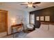 Bedroom with desk, upholstered bed, ceiling fan and sitting area with window at 45 Oak Way, Evergreen, CO 80439