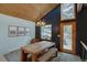 Dining room featuring a wooden table, antler chandelier, wood ceiling, and view of snowy landscape at 45 Oak Way, Evergreen, CO 80439