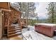 Outdoor hot tub with wooden deck and serene mountain views at 45 Oak Way, Evergreen, CO 80439