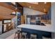 View of a kitchen with dark blue cabinets, stainless steel appliances, and wood ceiling at 45 Oak Way, Evergreen, CO 80439
