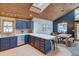 Charming kitchen featuring ample countertop space, custom cabinetry, and a skylight allowing natural light to fill the room at 45 Oak Way, Evergreen, CO 80439