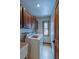 Laundry room with overhead wood cabinets, washer, dryer, and a window at 45 Oak Way, Evergreen, CO 80439