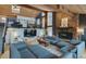 Inviting living room featuring stone fireplace, wood beamed ceiling and comfortable seating area at 45 Oak Way, Evergreen, CO 80439
