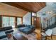 Cozy living room features wood ceiling, stone accents and comfortable sofa at 45 Oak Way, Evergreen, CO 80439