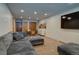 Well-lit living room with a sectional sofa, dining area, and a flat-screen television at 45 Oak Way, Evergreen, CO 80439