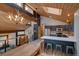 View of a living space featuring kitchen, dining area, and living room with wooden ceilings and modern lighting at 45 Oak Way, Evergreen, CO 80439