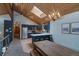 Open living space with wood ceiling, featuring a kitchen, dining area, and unique antler chandelier at 45 Oak Way, Evergreen, CO 80439