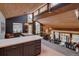 Open living space with cathedral wood ceiling, dining area, and kitchen with views of the outdoors at 45 Oak Way, Evergreen, CO 80439