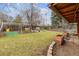 Spacious backyard with well-maintained lawn, mature tree, and swing set perfect for outdoor recreation at 615 Estes St, Lakewood, CO 80215