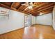 Spacious basement with wood ceiling, laminate flooring, and sliding glass door to backyard at 615 Estes St, Lakewood, CO 80215