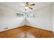 Cozy bedroom with hardwood floors, large windows, and ceiling fan at 615 Estes St, Lakewood, CO 80215