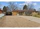 Ranch-style home featuring a large driveway, carport, and a fenced yard, perfect for outdoor living at 615 Estes St, Lakewood, CO 80215