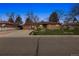 Charming brick home with a well-manicured lawn, and spacious driveway, offering a welcoming curb appeal at 615 Estes St, Lakewood, CO 80215