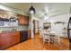 Well-lit kitchen with wooden cabinets, modern appliances, and a cozy dining area at 615 Estes St, Lakewood, CO 80215