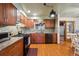 Modern kitchen featuring granite countertops, stainless steel appliances, and hardwood floors at 615 Estes St, Lakewood, CO 80215