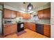 Cozy kitchen featuring wood cabinets, granite countertops, tiled backsplash and black appliances at 615 Estes St, Lakewood, CO 80215