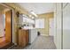 Well-lit laundry room features washer, dryer, storage cabinets, and neutral-toned walls and flooring at 615 Estes St, Lakewood, CO 80215