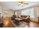 Cozy living room featuring hardwood floors, a large window, and comfortable seating at 615 Estes St, Lakewood, CO 80215