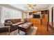 Bright living room featuring hardwood floors, a large window, and a wooden entertainment center at 615 Estes St, Lakewood, CO 80215