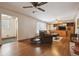 Spacious living room boasting hardwood floors, ceiling fans, a large window and a wooden entertainment center at 615 Estes St, Lakewood, CO 80215