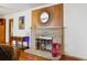 Charming fireplace with decorative stone surround and wooden accents at 615 Estes St, Lakewood, CO 80215