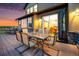 Outdoor living space features a dining table, chairs, and lounge area with views of the backyard and surrounding area at 10705 Pinewalk Way, Highlands Ranch, CO 80130