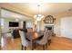 Stylish dining area open to the living room, featuring a fireplace and hardwood flooring at 10705 Pinewalk Way, Highlands Ranch, CO 80130