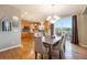 Charming dining area with adjacent kitchen, chandelier, and sliding doors to the outdoor space at 10705 Pinewalk Way, Highlands Ranch, CO 80130