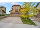 Charming two-story home with a well-maintained lawn and driveway leading to a two-car garage at 10705 Pinewalk Way, Highlands Ranch, CO 80130